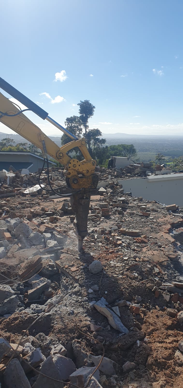Hydraulic breaker attachment breaking concrete rubble