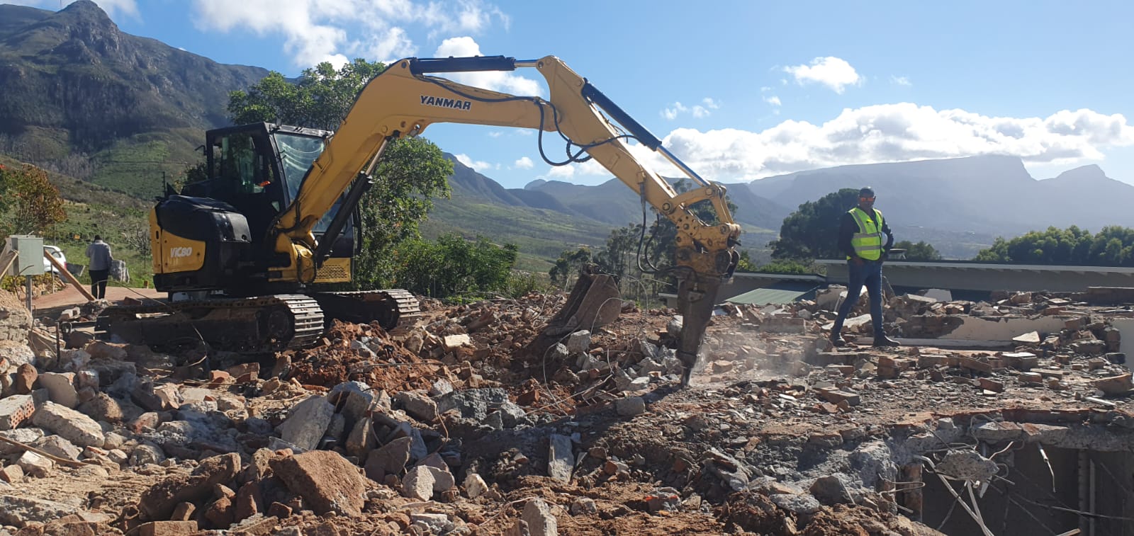 CCS excavator with hydraulic breaker working on a demolition site in the Western Cape