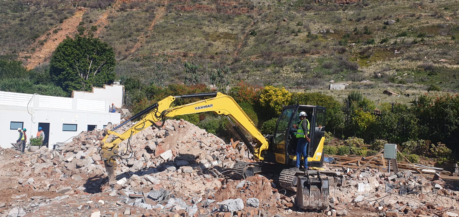 Yanmar mini excavator fitted with breaker on a demolition site