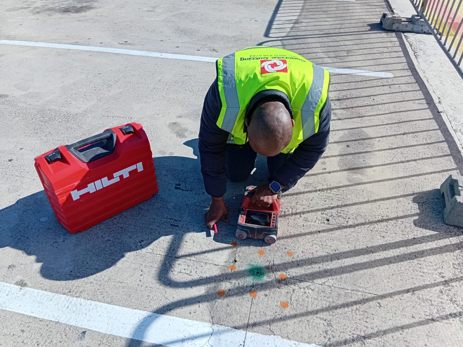 Hilti concrete scanner being used to mark detected positions on a slab